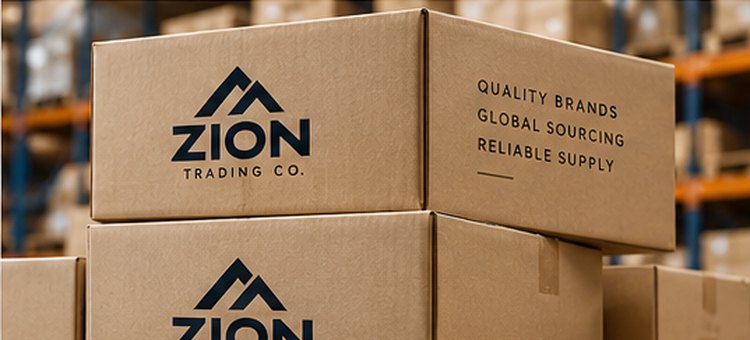 Stacked cardboard shipping boxes printed with the Zion Trading Co. logo in a warehouse